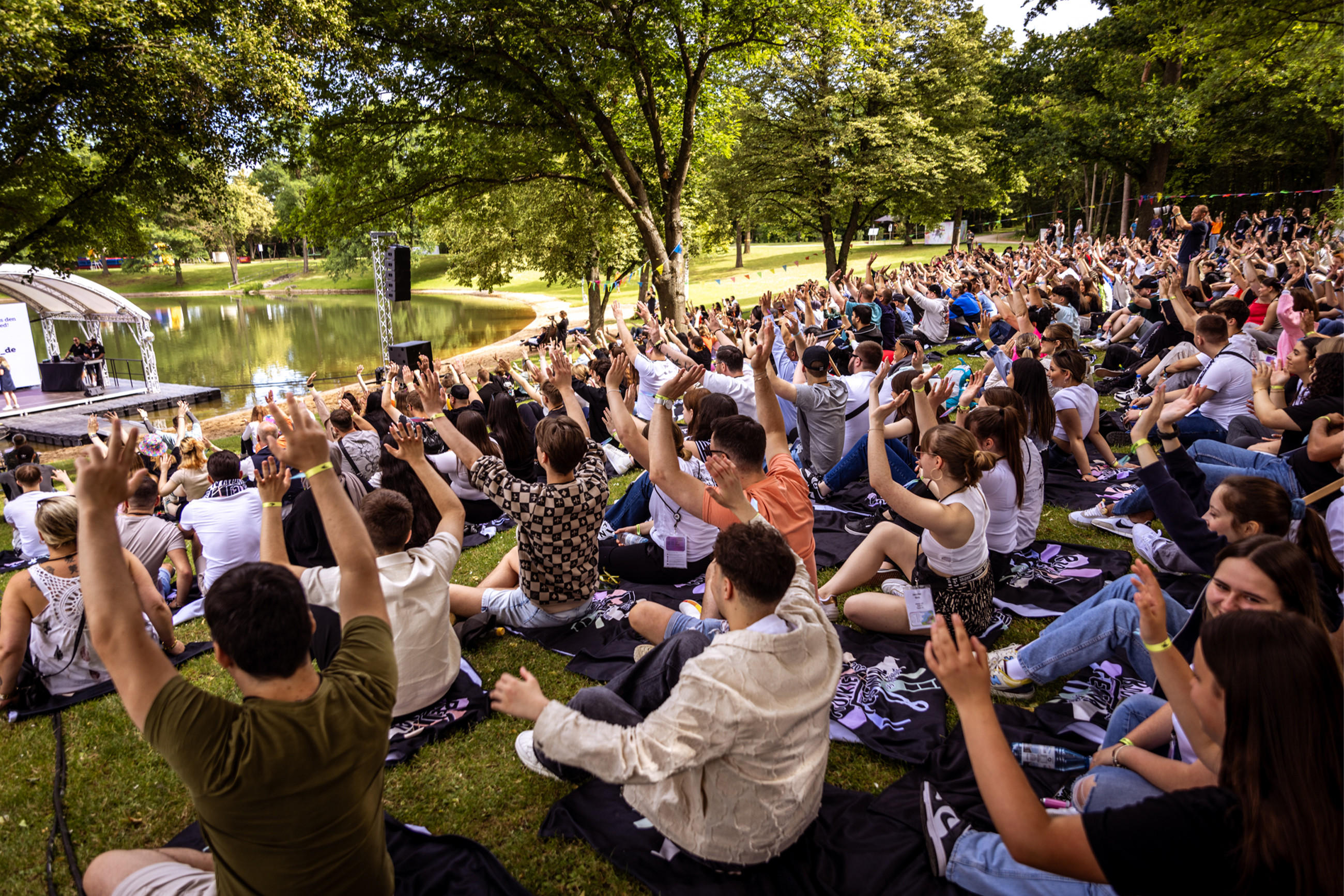 XXXLutz Azubis sitzen auf dem Gras und genießt die Natur beim Rookie Festival 2024
