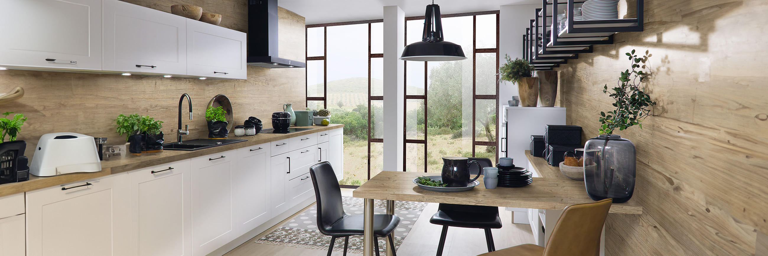 Küche in weiß mit Holzakzenten, Arbeitsplatte aus Holz, Eckbank und Sitzgruppe in der Küche, schwarze Dunstabzugshaube, Schwarze Spüle