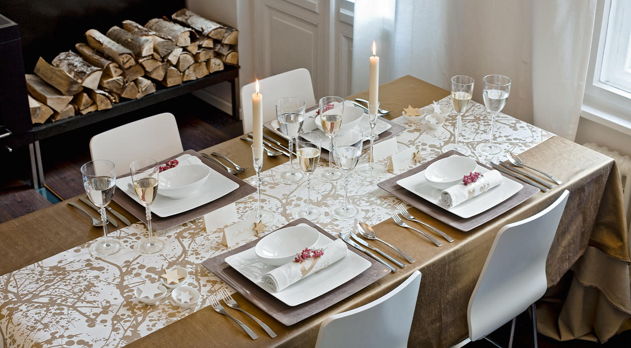 Festlich gedeckter Esstisch mit hochwertigem Geschirr, Gläsern und dekorativen Kerzen. Perfekt für besondere Anlässe oder ein stilvolles Dinner