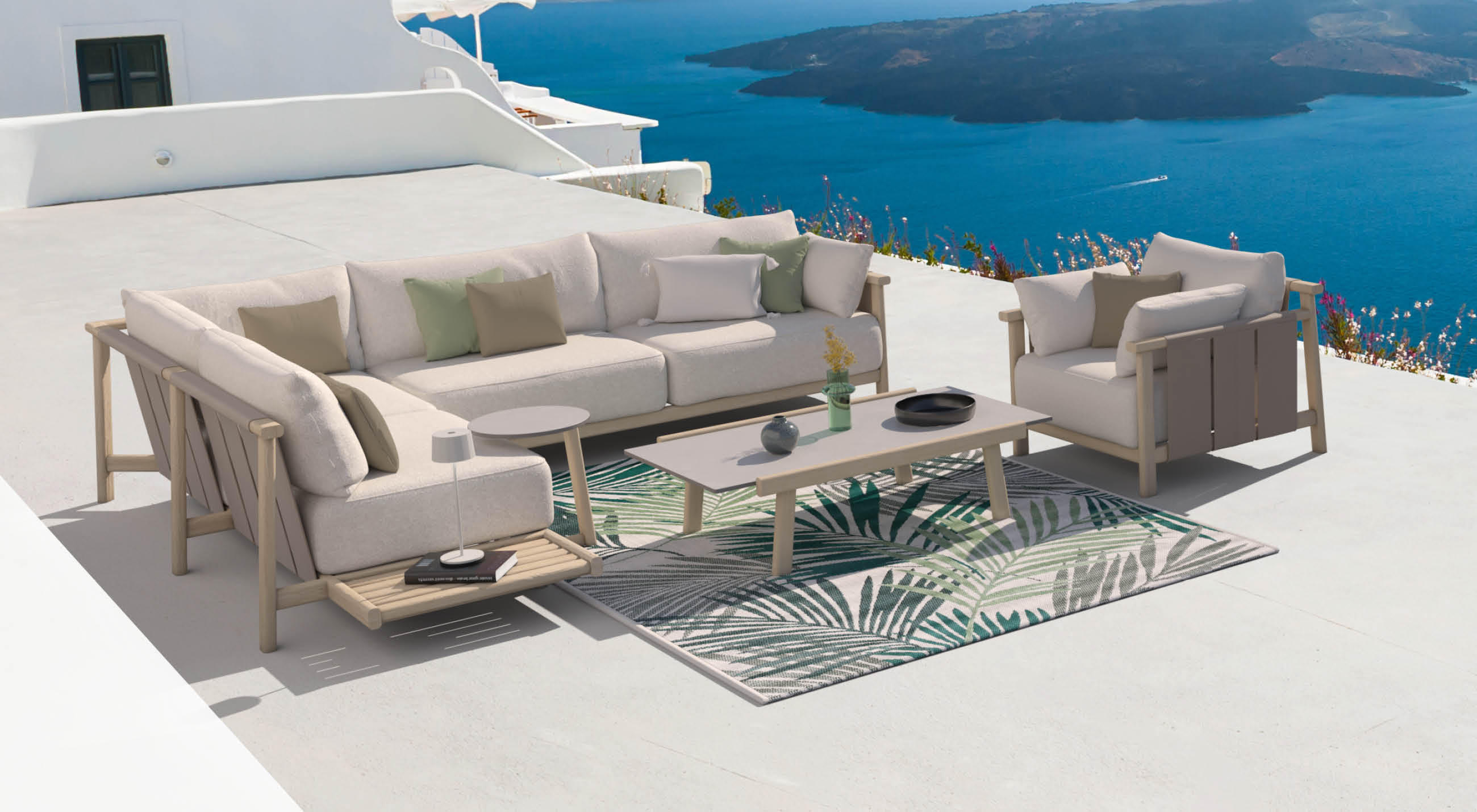 Helle Outdoor-Lounge mit Sofa, Sessel und Couchtisch auf weißer Terrasse, dahinter tiefblaues Meer und Inseln.