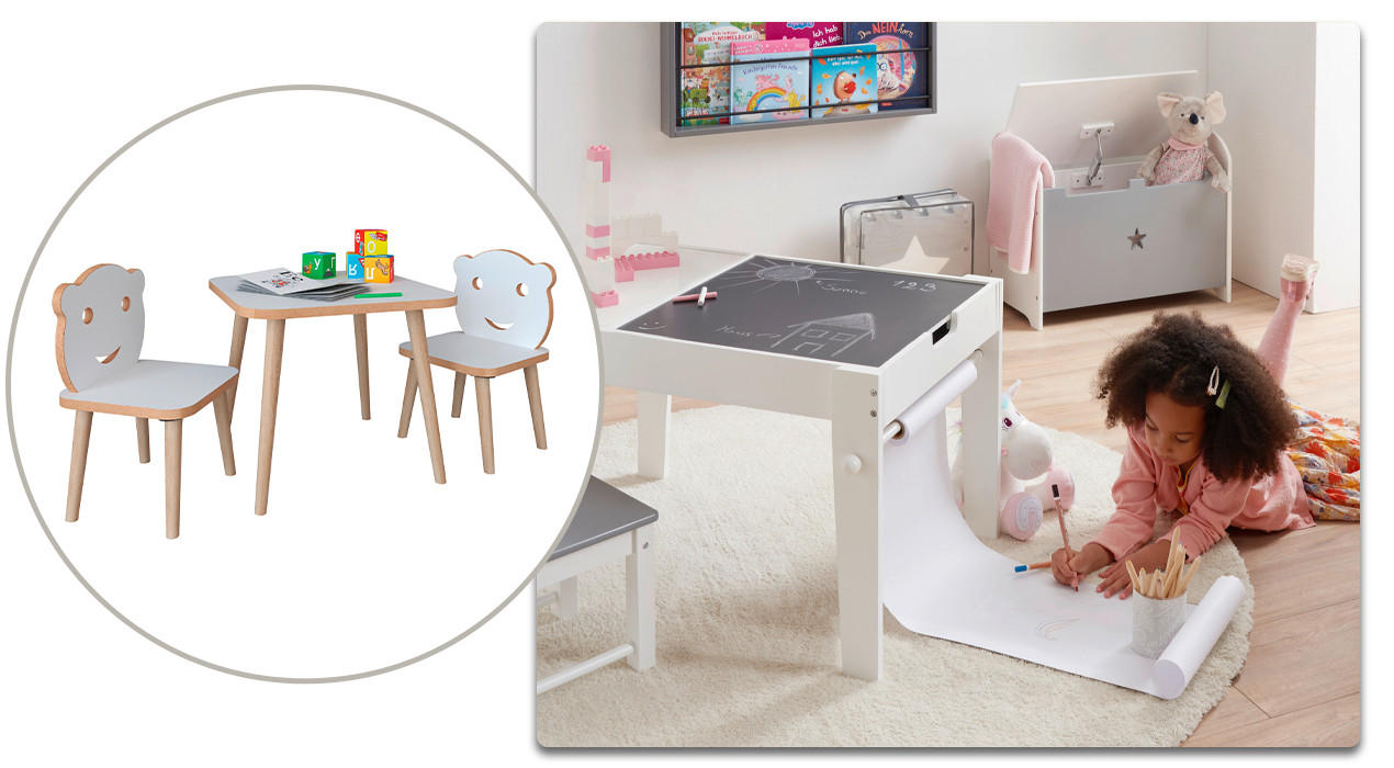 Kind malt am Boden neben einem Kindertisch
