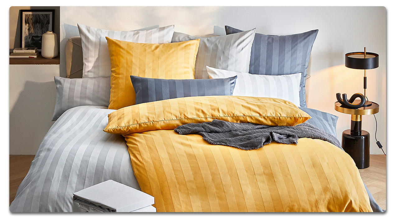 Bett mit Bettwäsche in Farben - gemütliches Schlafzimmer gestalten