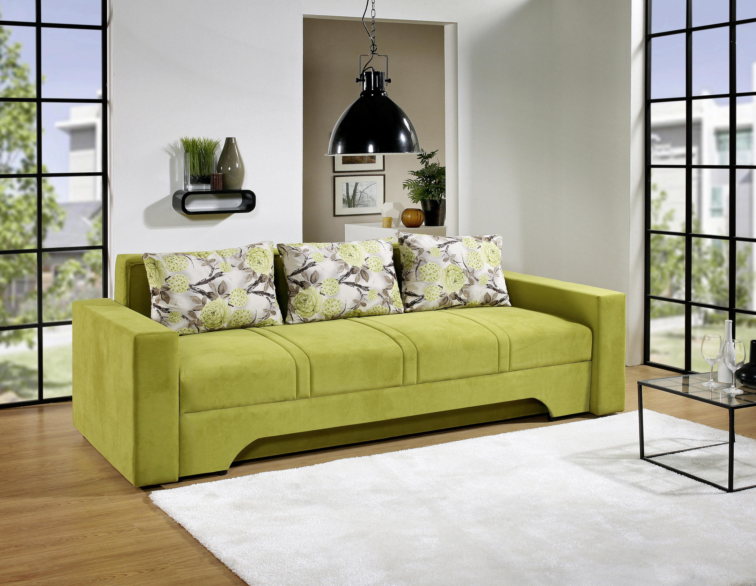 Praktičen trosed, ki lahko služi kot pomožno ležišče v zeleni barvi.