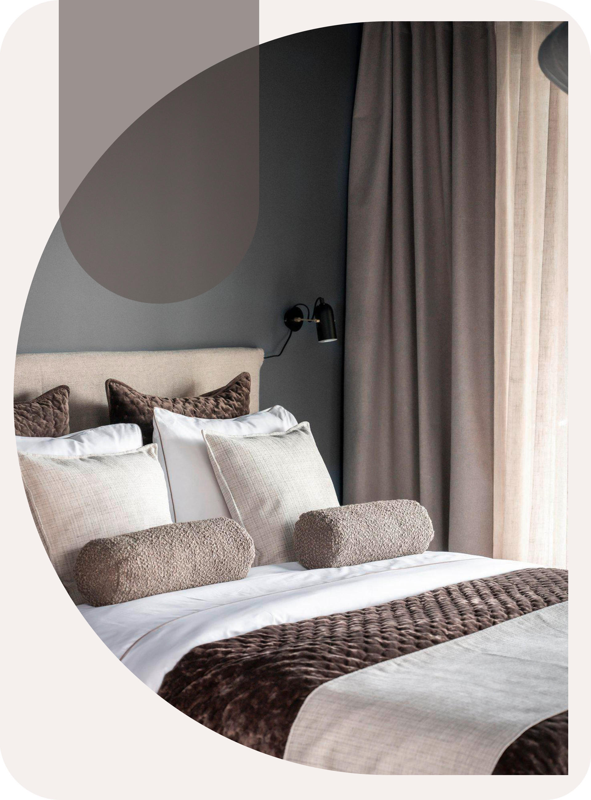 Modernes Schlafzimmer in warmen Erdtönen. Großes Bett mit vielen Kissen.