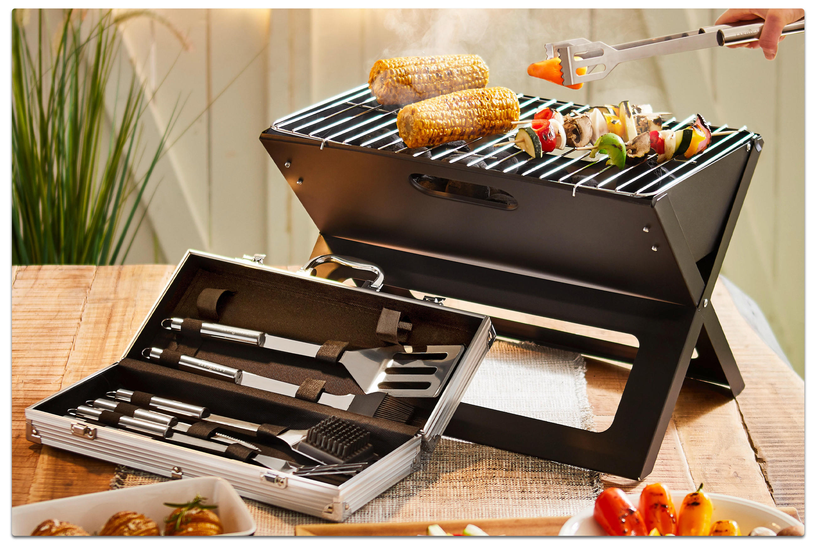 Grill mit Speisen und Grillzubehör