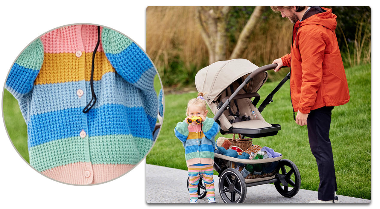 Baby mit bunter Strickjacke