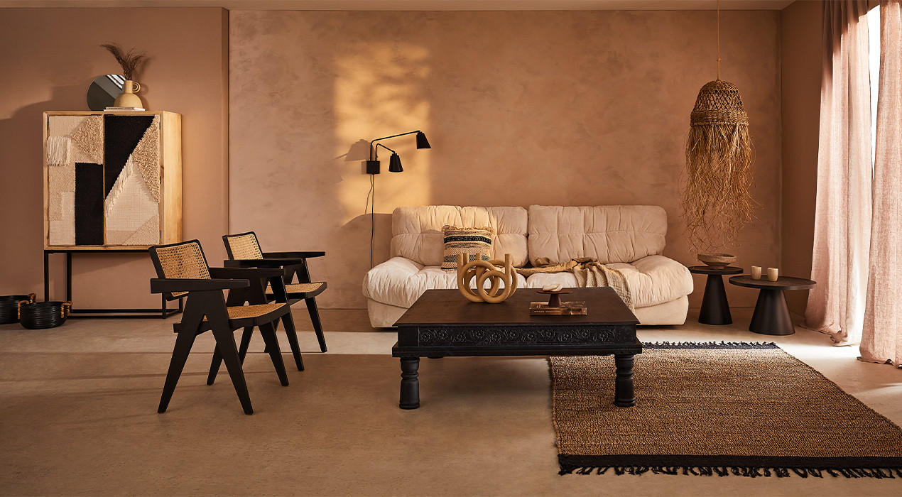 Boho-inspirierter Raum mit warmen Farben, künstlerischer Dekoration und vielfältigen Möbelstücken