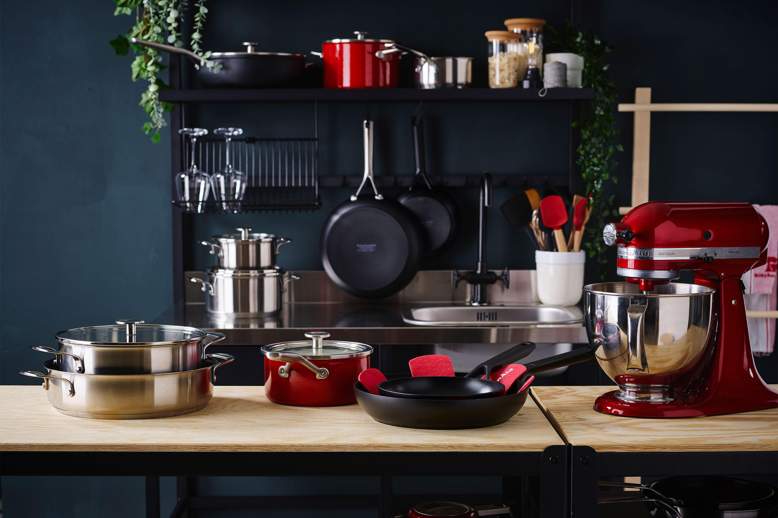 Kitchenaid-Küchenutensiliensammlung in verschiedenen Farben und Designs auf einem Tisch angeordnet.