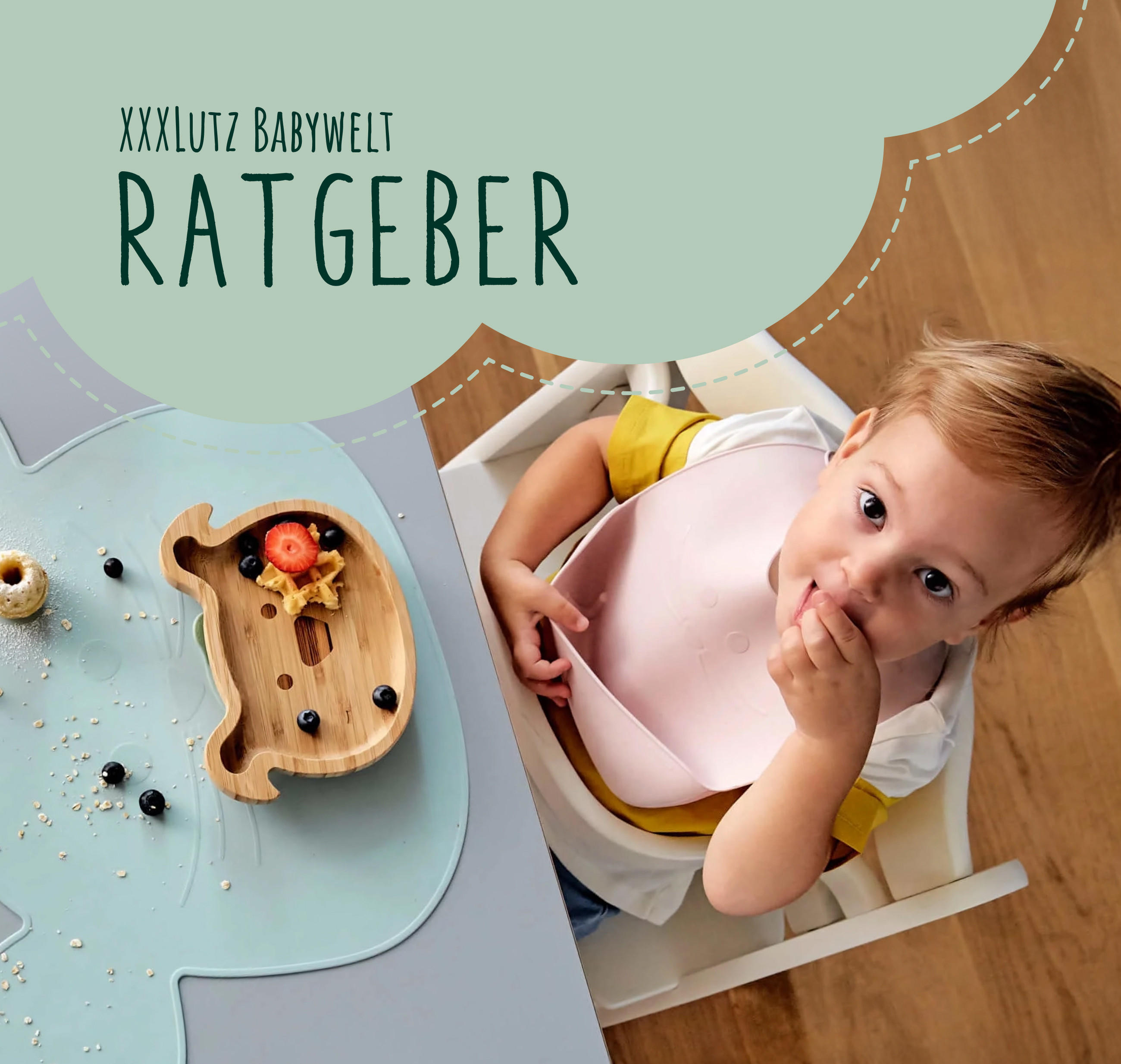 Ein Kleinkind sitzt im Hochstuhl mit einem rosa Lätzchen und isst mit den Fingern. Auf dem Tisch liegen ein kindgerechter Teller und eine Holzschale mit Obst; links steht in einer grünen Sprechblasen-Grafik ‚XXXLutz Babywelt Ratgeber‘.