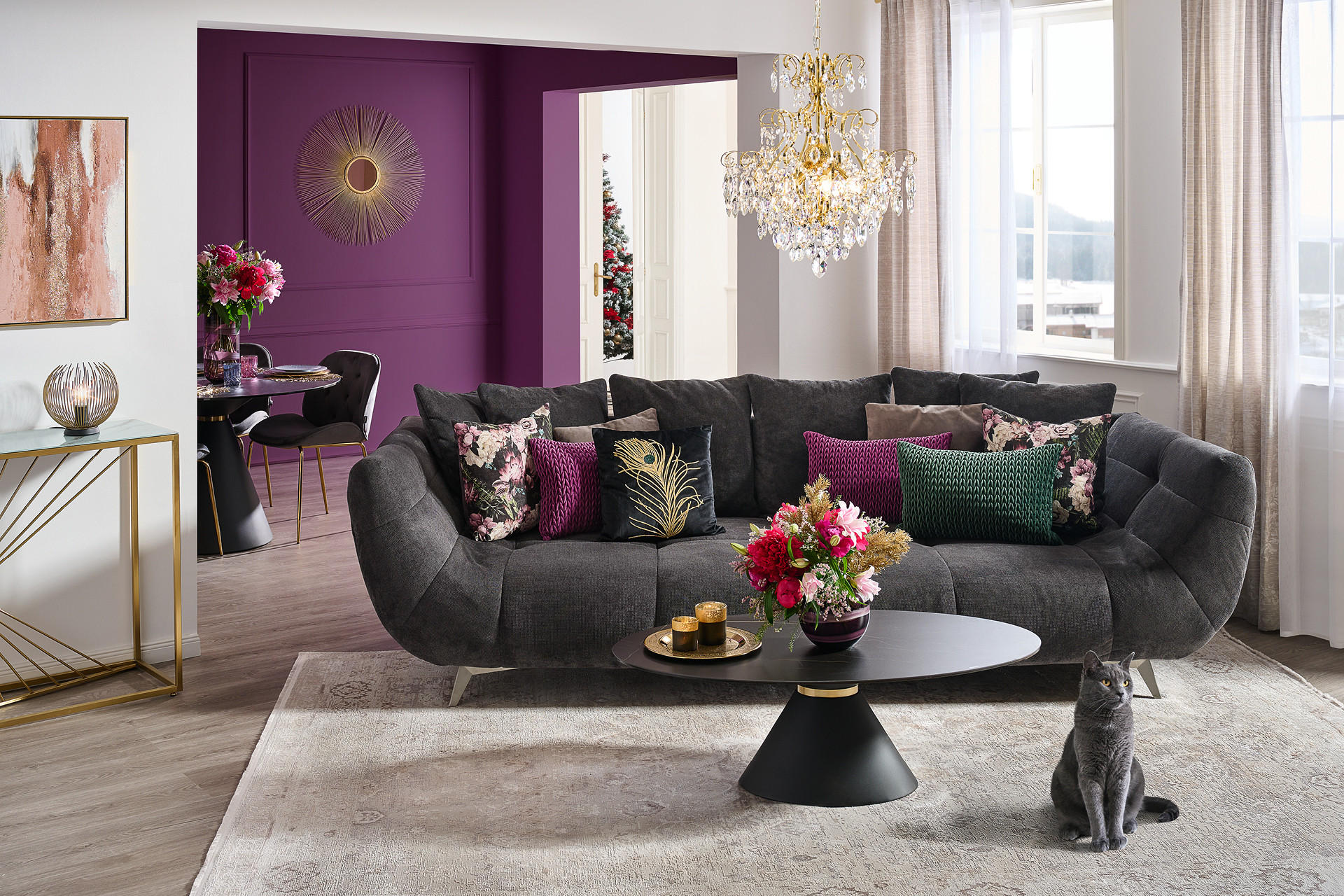 Schwarzes Sofa, davor schwarzer Runder Couchtisch