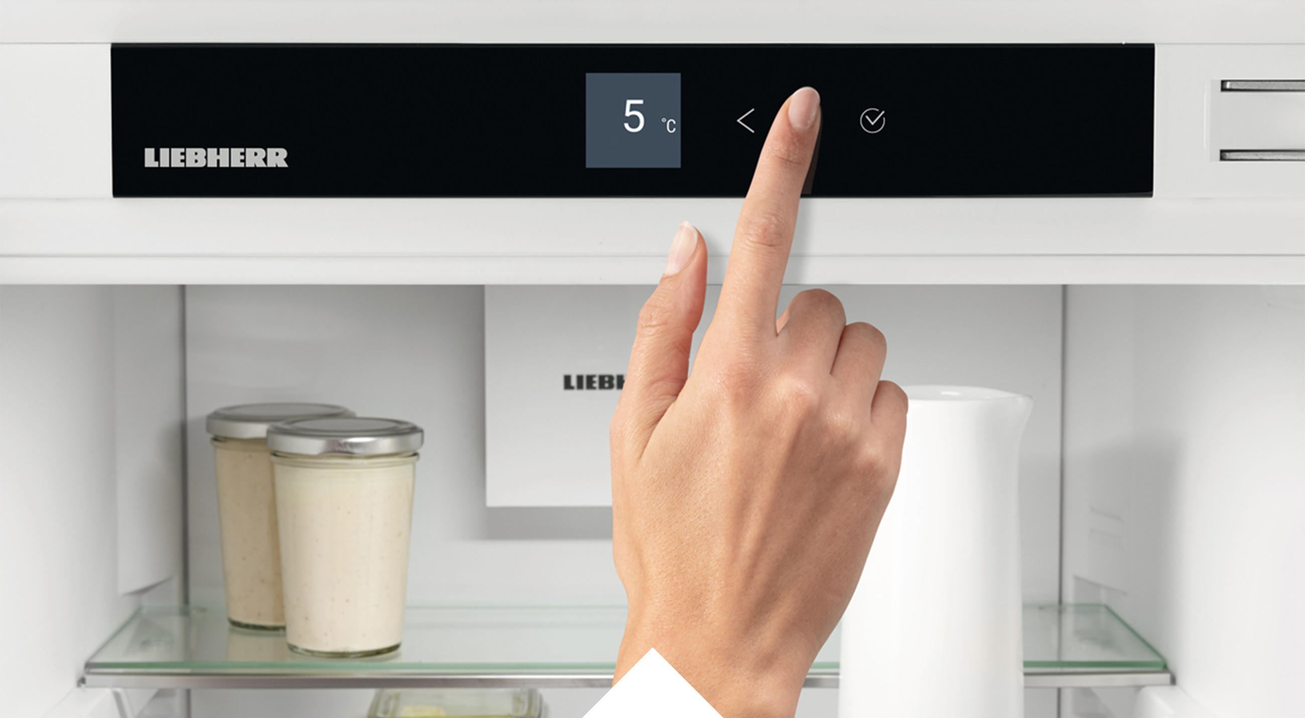Hand bedient das Touch-Display eines Liebherr-Kühlgeräte.