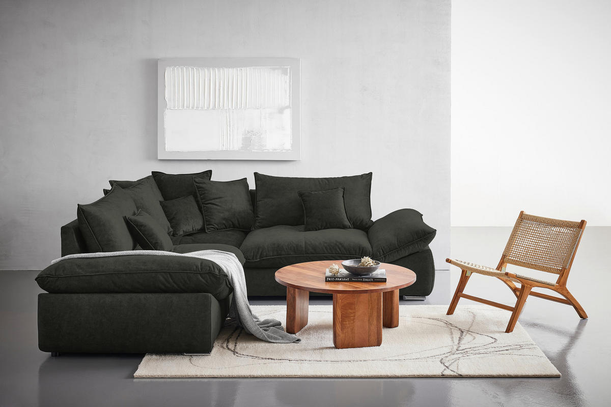 Carryhome ECKSOFA Dunkelgrün Velours, rechts davon: Hochflorteppich, Couchtisch in braun, Stuhl in gelb, Kissen in hellem Wohnzimmer.